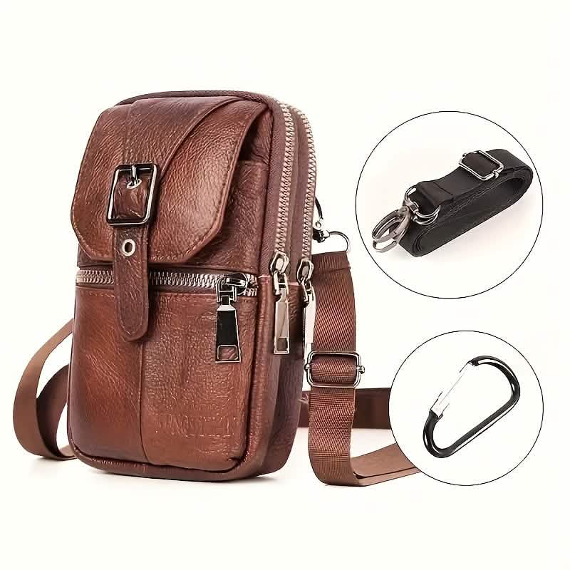Brown leather crossbody bag with additional strap and carabiner on a white background