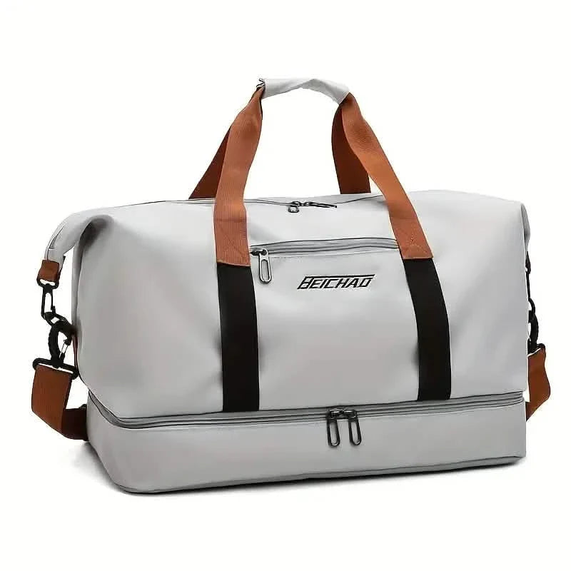 Gray duffel bag with brown straps and black accents on a white background